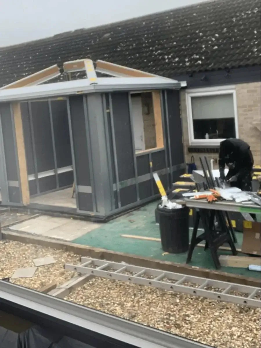 Completed HUP! extension featuring dark composite cladding and anthracite grey French doors. Exterior by Norfolk Exterior Solutions